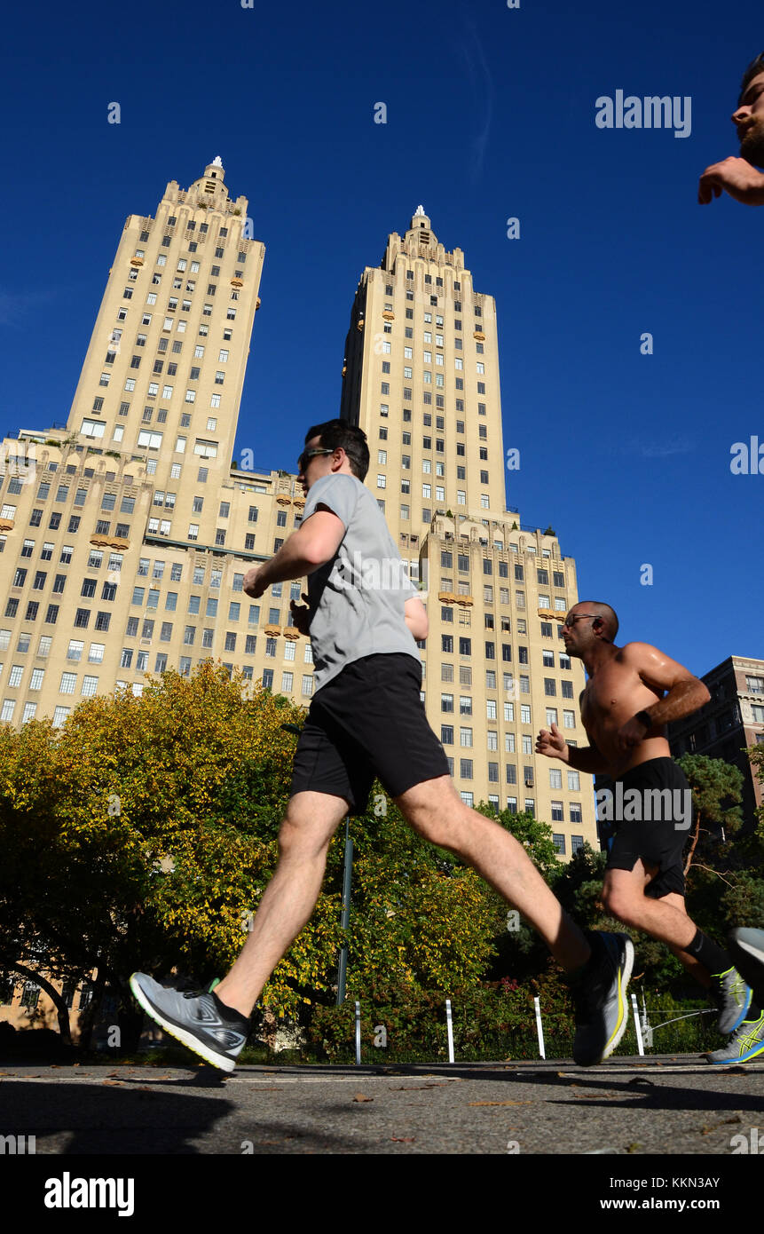 Joggers run around the Schuman Running Track in Central Park with The