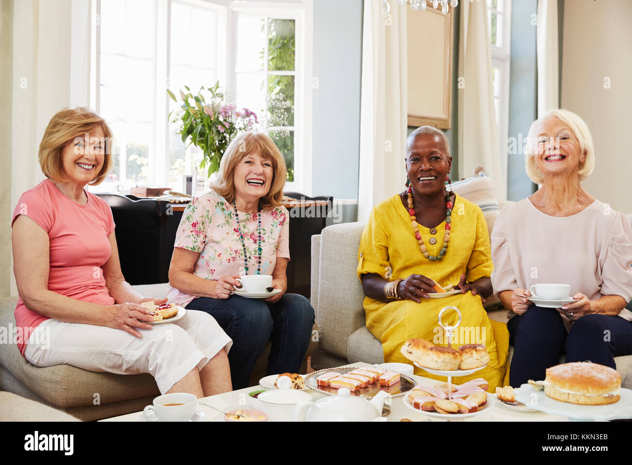 Portrait Of Senior Female Friends Enjoying Afternoon Tea At Home Stock Photo