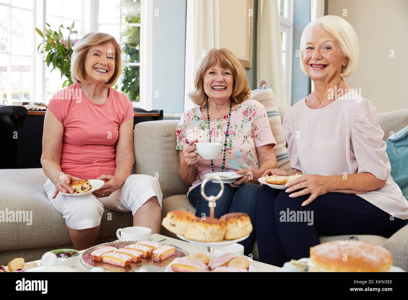 Portrait Of Senior Female Friends Enjoying Afternoon Tea At Home Stock Photo