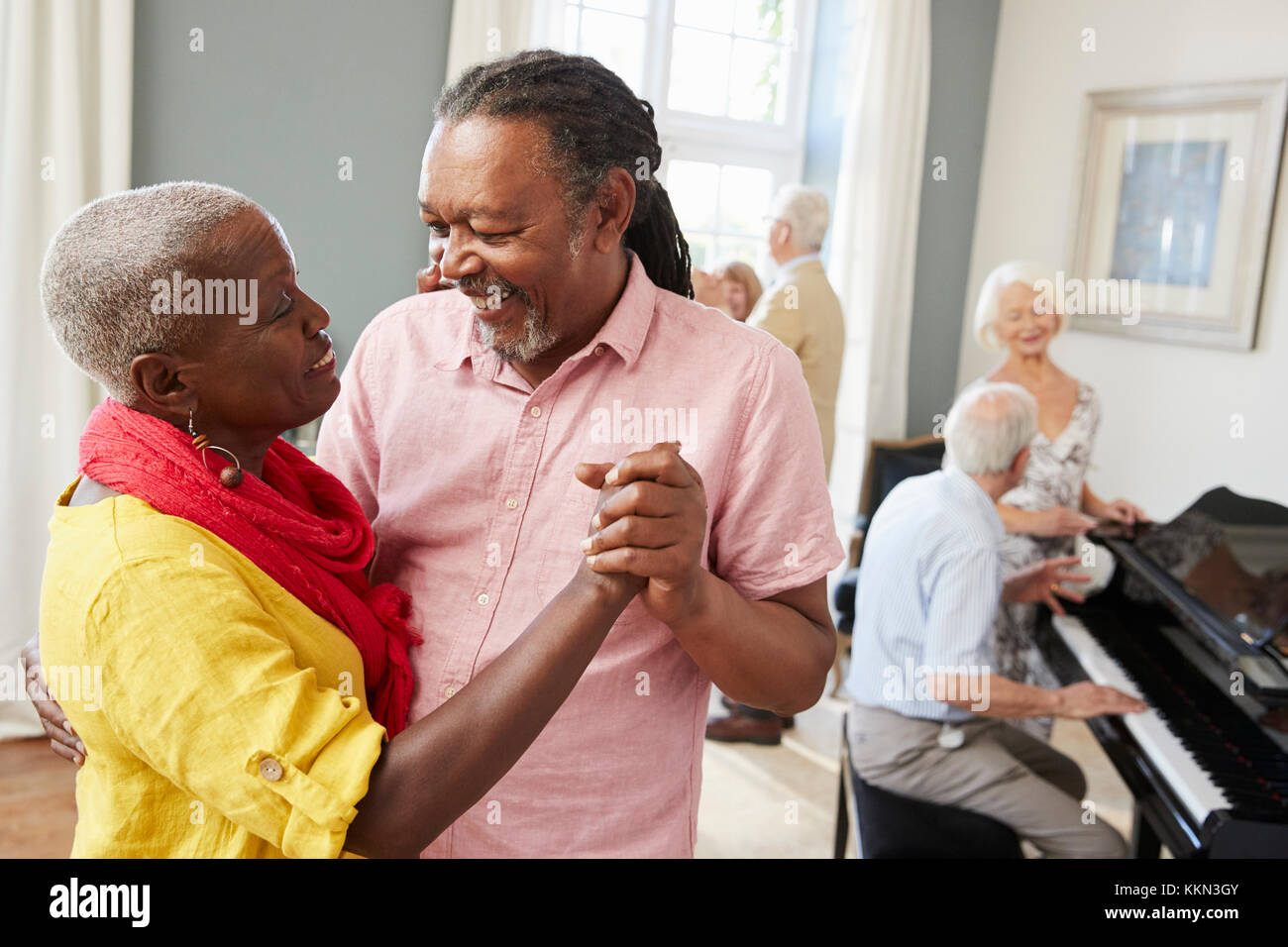 Group Of Seniors Enjoying Dancing Club Together Stock Photo