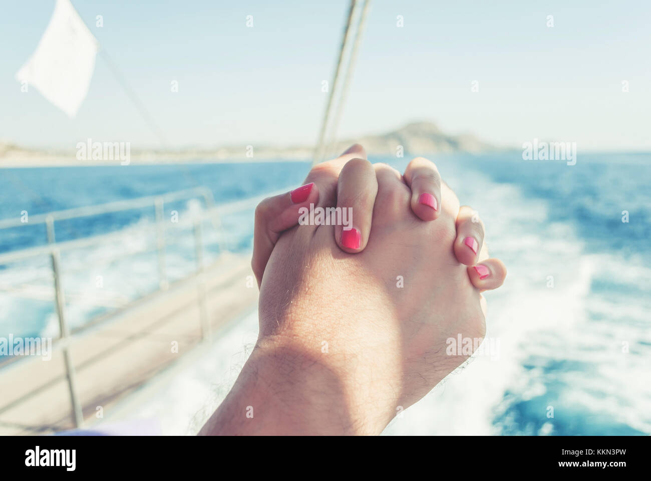 Man and woman holding hands, on a yacht, freedom and love of the sea Stock Photo