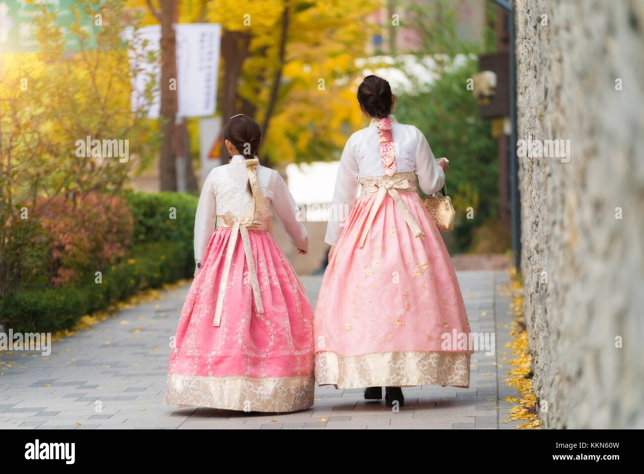 Asian Korean woman dressed Hanbok in traditional dress walking in Jeongdong-gil in Seoul, South Korea. Stock Photo