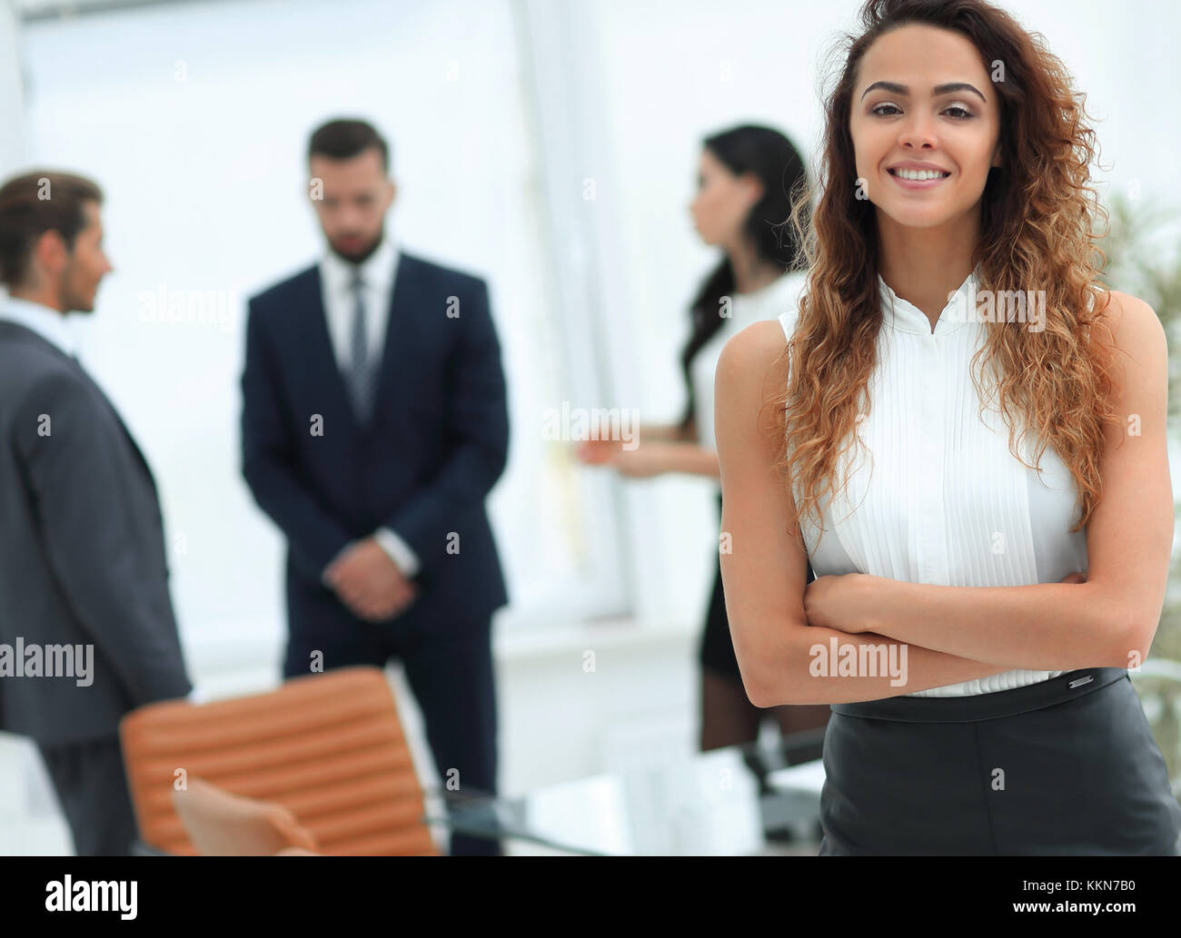 beautiful woman on the background of business people Stock Photo - Alamy