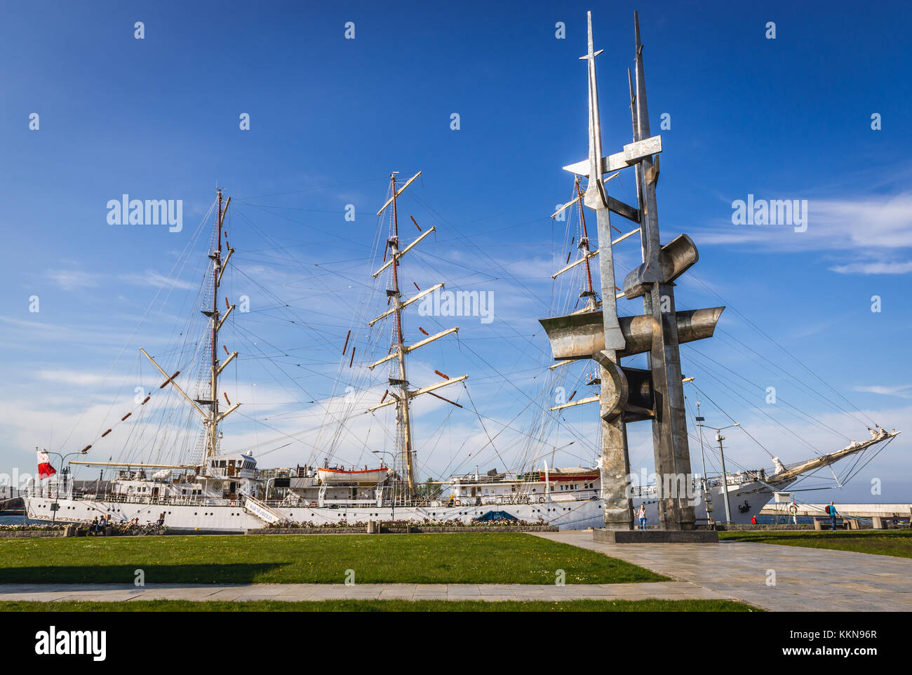 Sail training ship Dar Mlodziezy (Gift of the Youth) and Sails Monument in Port of Gdynia city, Pomeranian Voivodeship of Poland Stock Photo