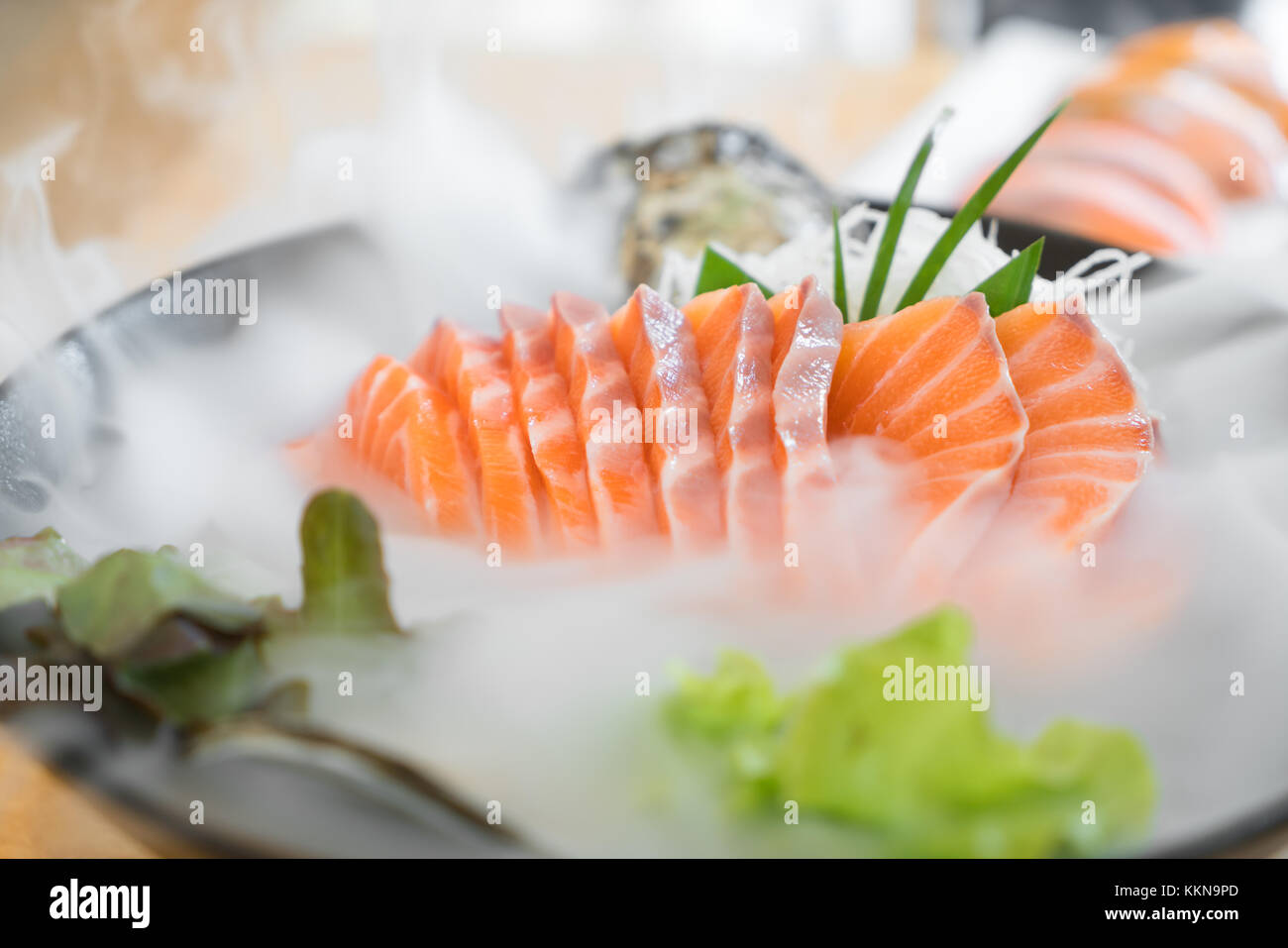Japan raw salmon slice or salmon sashimi in Japanese style fresh serve on ice in Japanese restaurant. Stock Photo