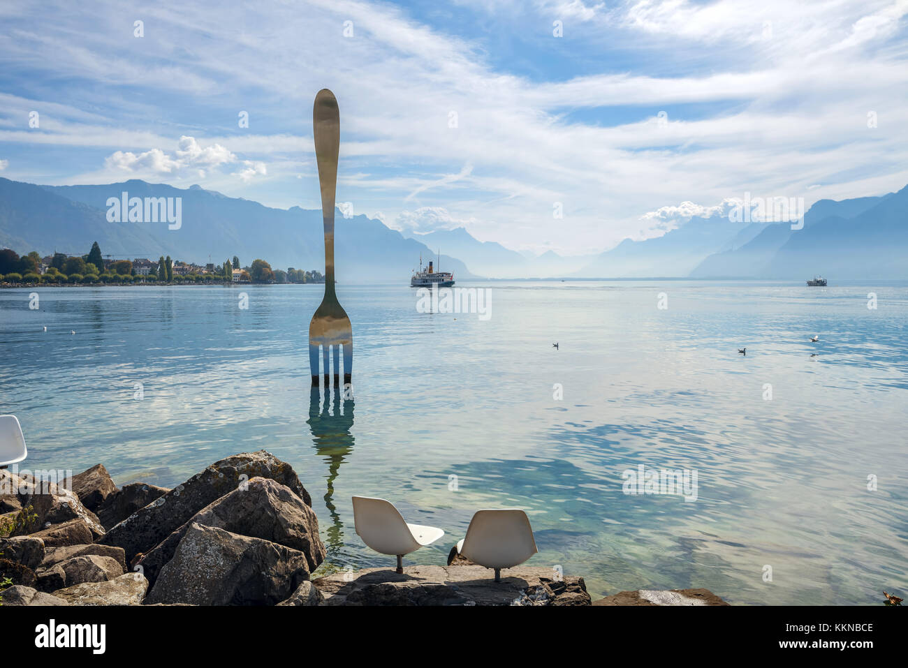 Landscape with fork sculpture in Geneva lake. Artist  Jean-Pierre Zaugg. Vevey, Switzerland Stock Photo