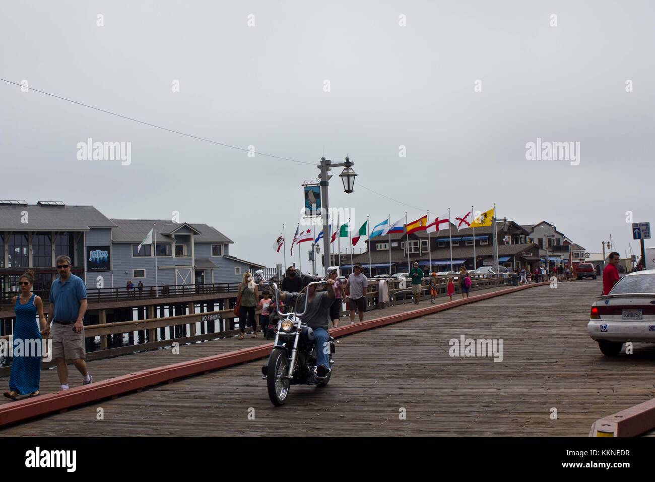 SANTA BARBARA, USA - AUG 15 2014: Grey day in Santa Barbara, California. Image taken from the pier with a moto and people walking Stock Photo