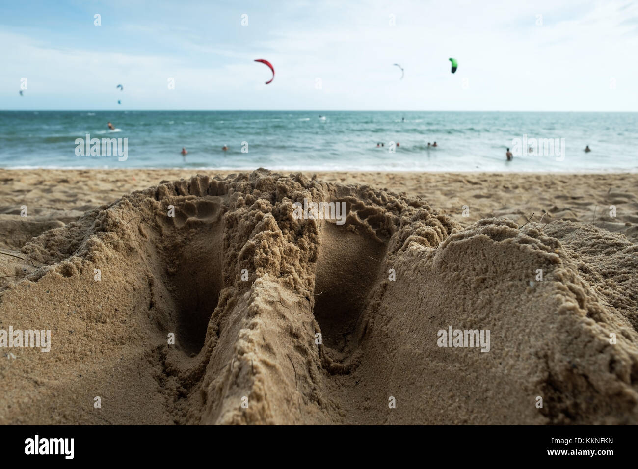 Close up of a man feet traces on sandy beach near the seashore. Stock Photo