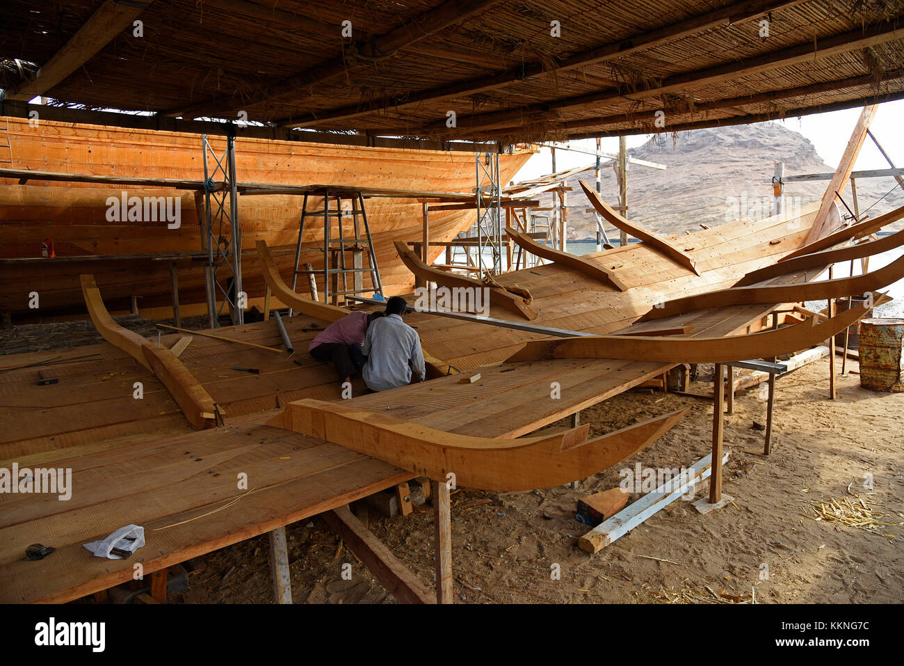 Oman Sur Workers at a shipyard building a dhow or traditional sailing vessel Stock Photo