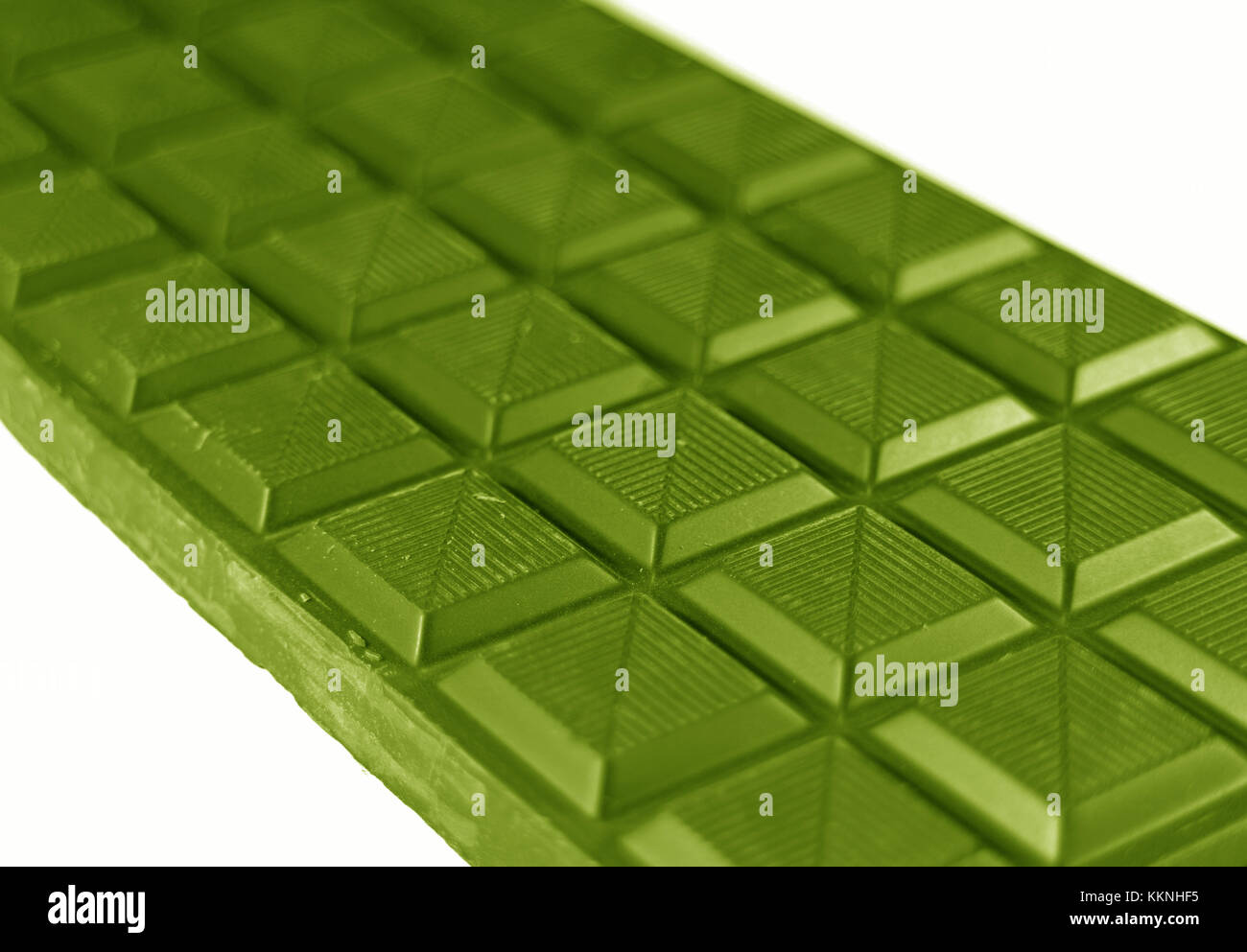 Closed up chocolate bar in olive green color on white background with selective focus Stock Photo