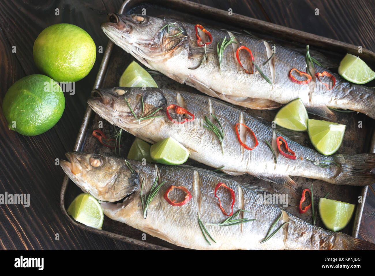 Baked sea bass with lime and chilli pepper Stock Photo Alamy