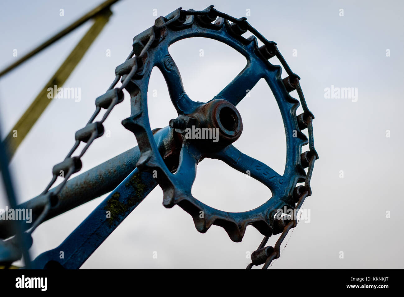 Old farm machinery on a farm. Root mechanisms and wheels in