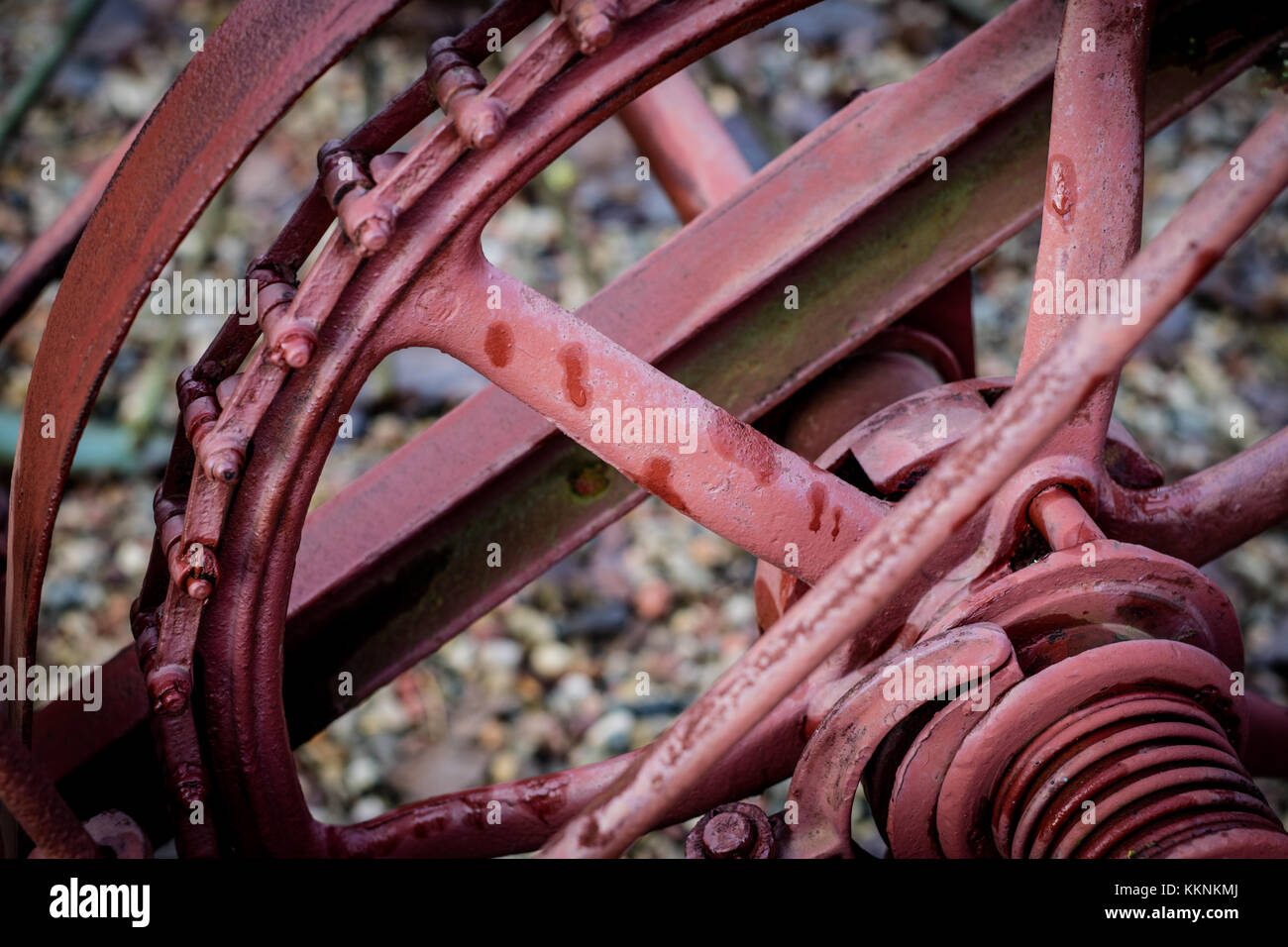 Old farm machinery on a farm. Root mechanisms and wheels in