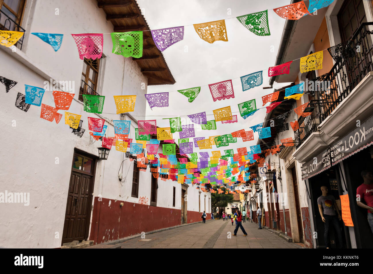 A pedestrian walkway decorated with colorful papel picado banners in Uruapan, Michoacan, Mexico. Stock Photo