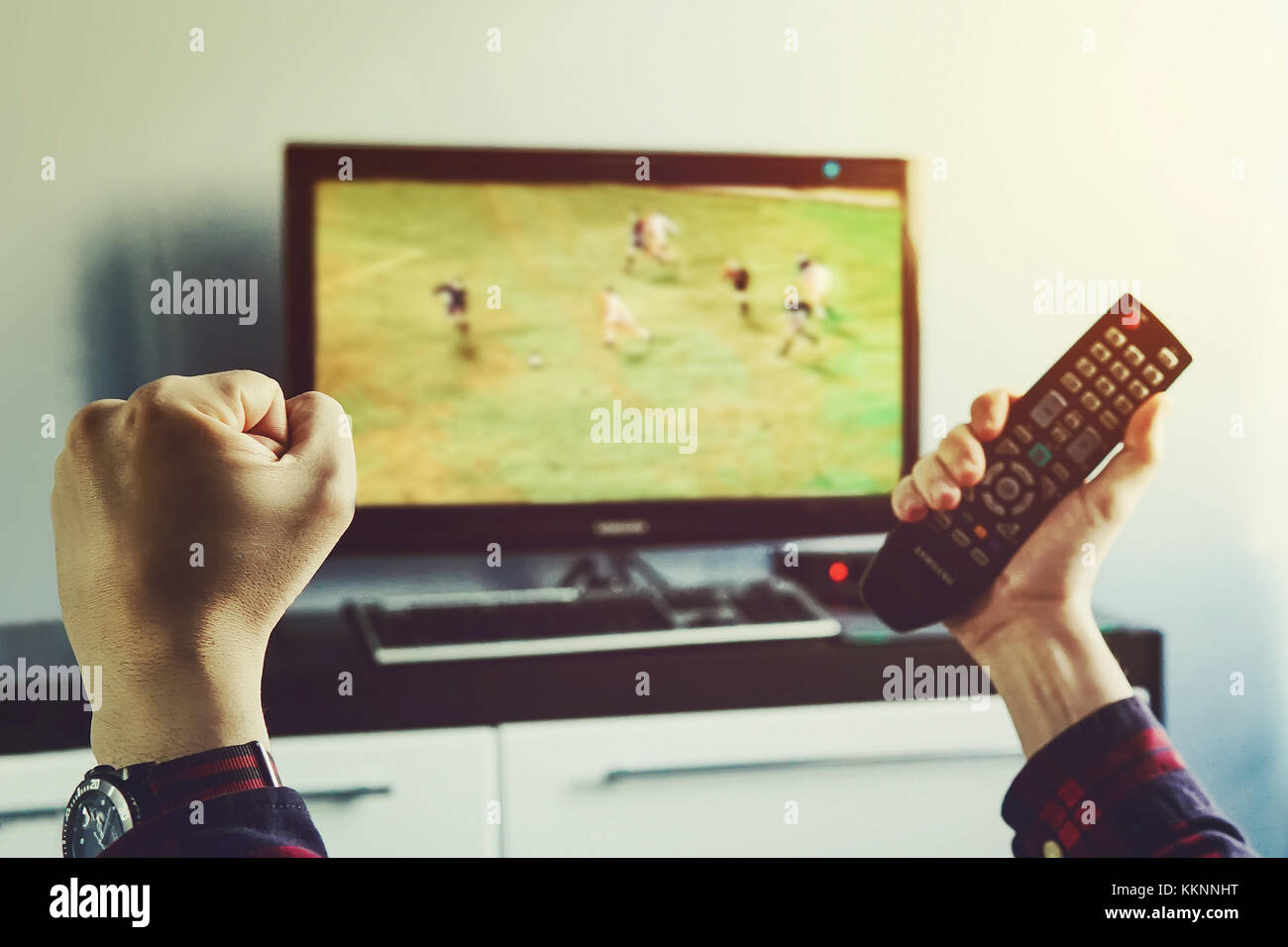 Goal. Man watching football match on television at home. remote control in hand. football fan watches world Cup soccer and more for your favorite foot Stock Photo
