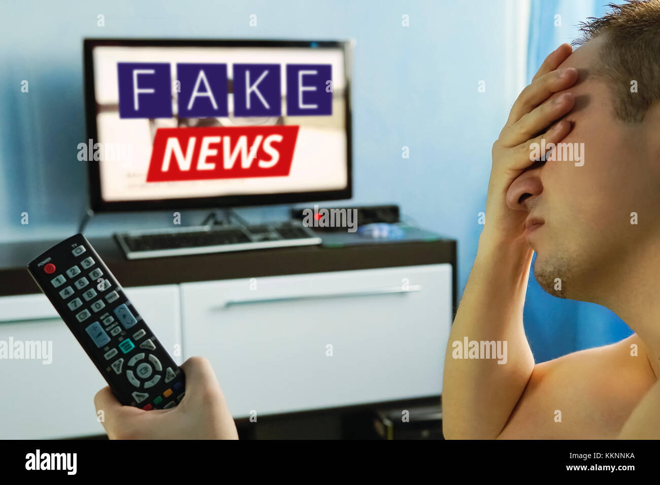 lies of tv propaganda mainstream media disinformation, A fake news report. viewer is watching TV and doesn't believe in fake news. man closes his eyes Stock Photo - Alamy