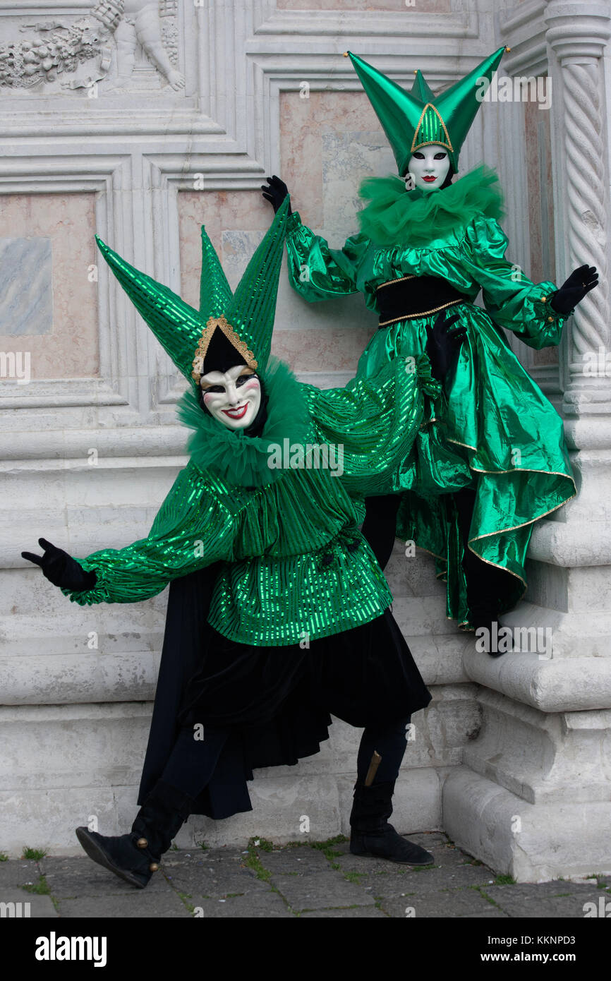 Man and woman in green and black Venetian costumes and masks, Venice Carnival, Venice Italy Stock Photo
