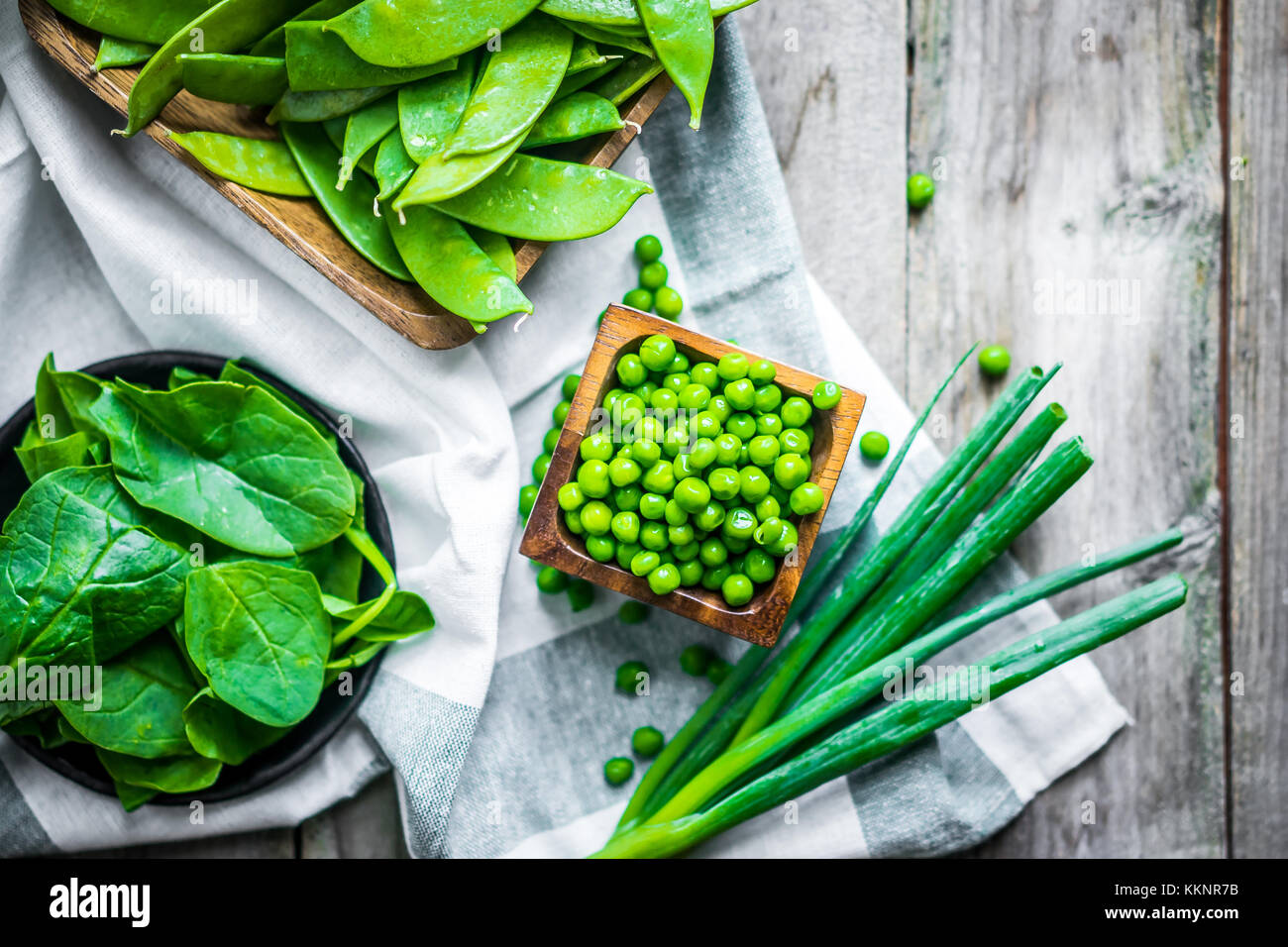Green vegetables on wooden background Stock Photo - Alamy