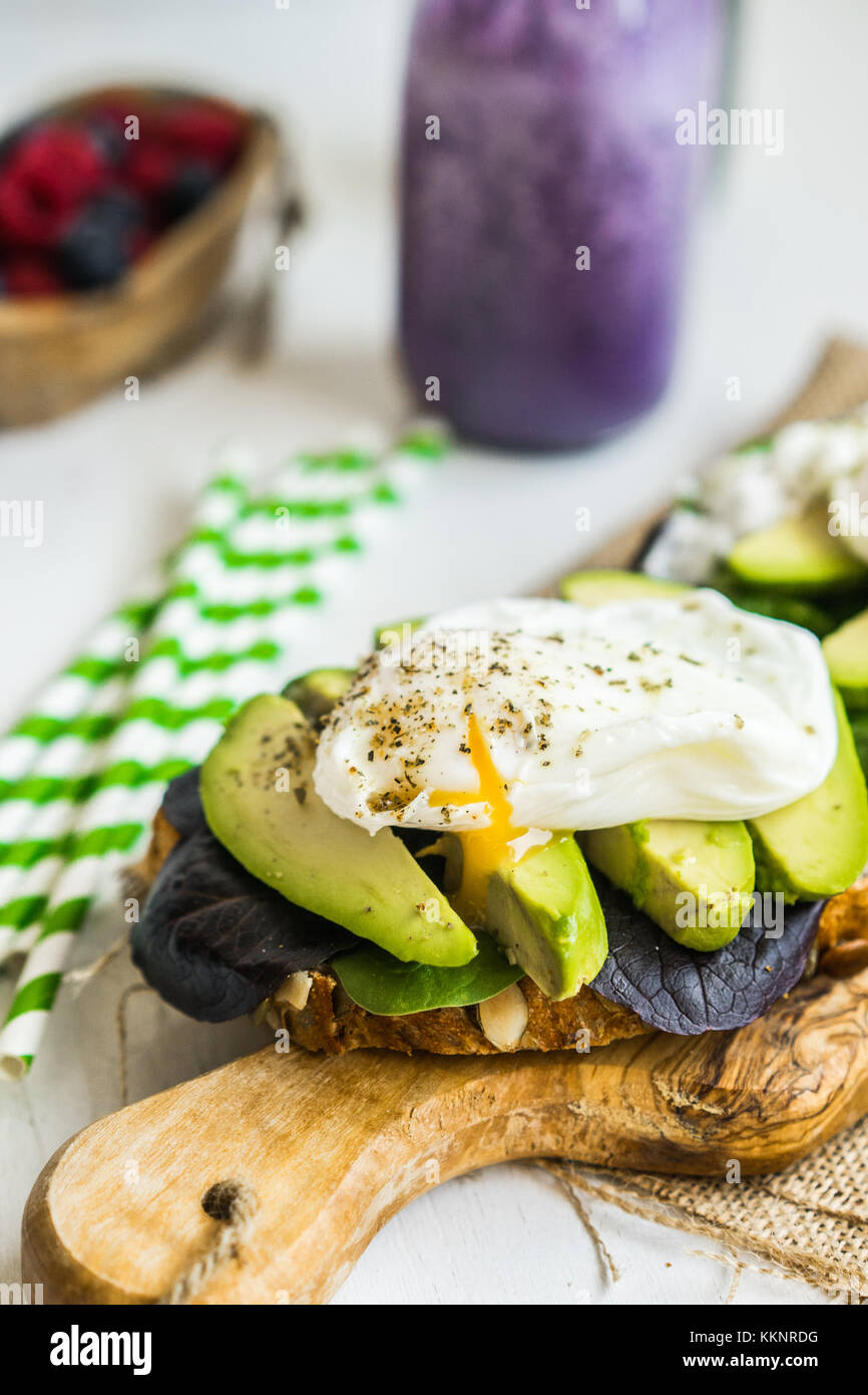 Healthy sandwich with avocado and poached eggs Stock Photo