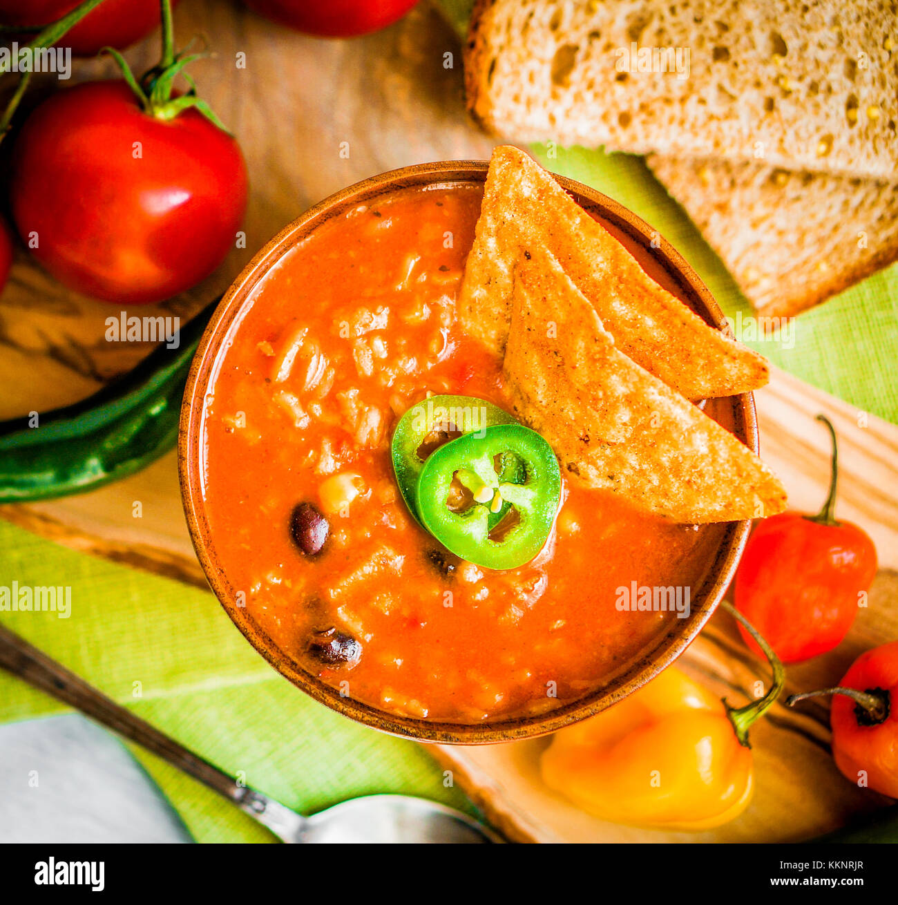 Hot And Spicy Fresh Made Mexican Chili Soup On Rustic Background Stock Photo