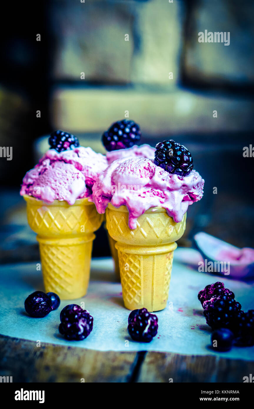 Ice Cream In Cones With Berries On Rustic Wooden Background Stock Photo