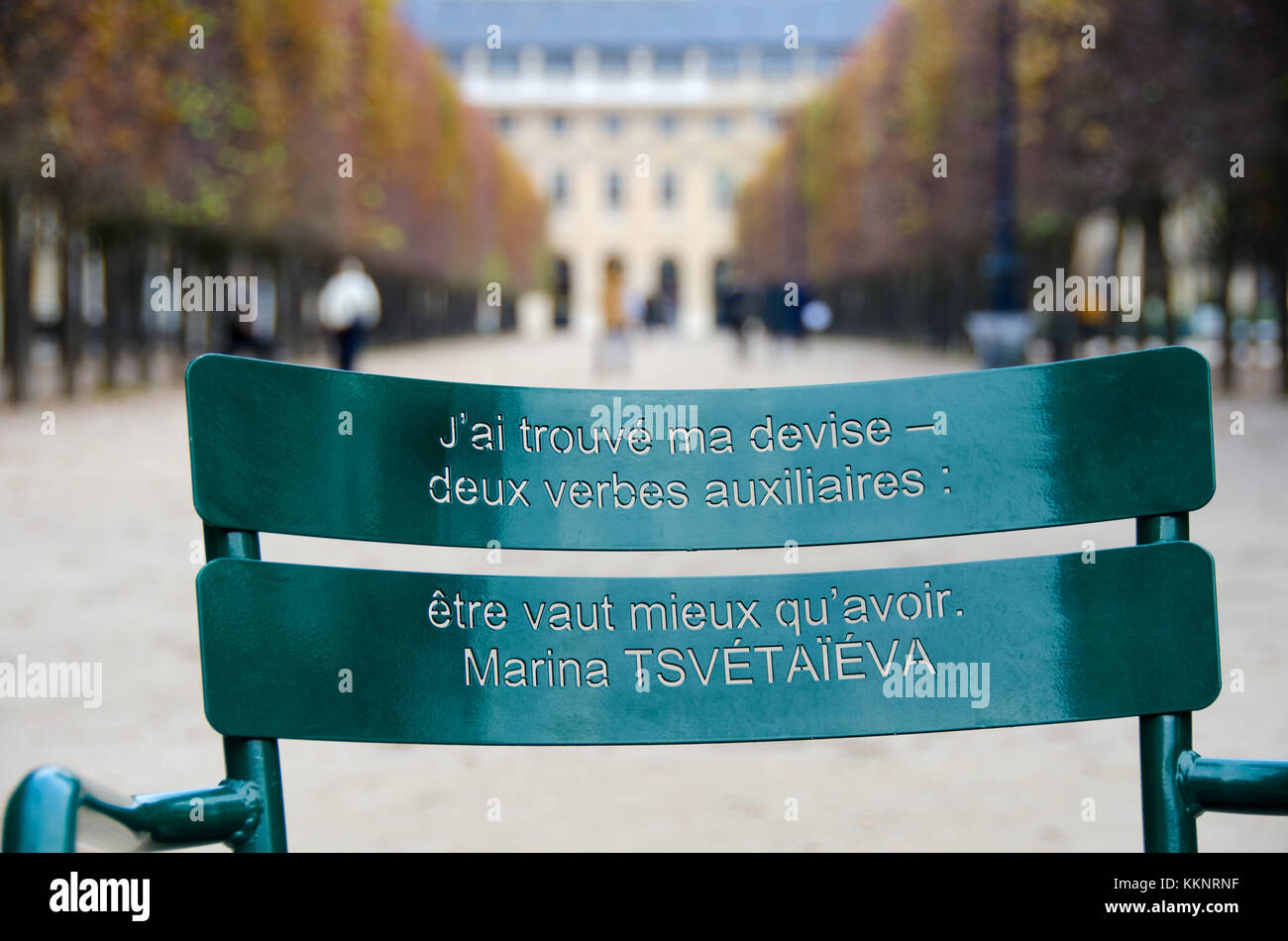 Paris, France. Palais Royal. Green chair: quotes cut in the back of old park chairs by Canadian artist Michel Goulet. Stock Photo