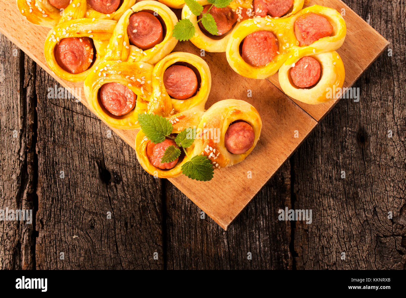 Mini hot dogs from above on the wooden board Stock Photo
