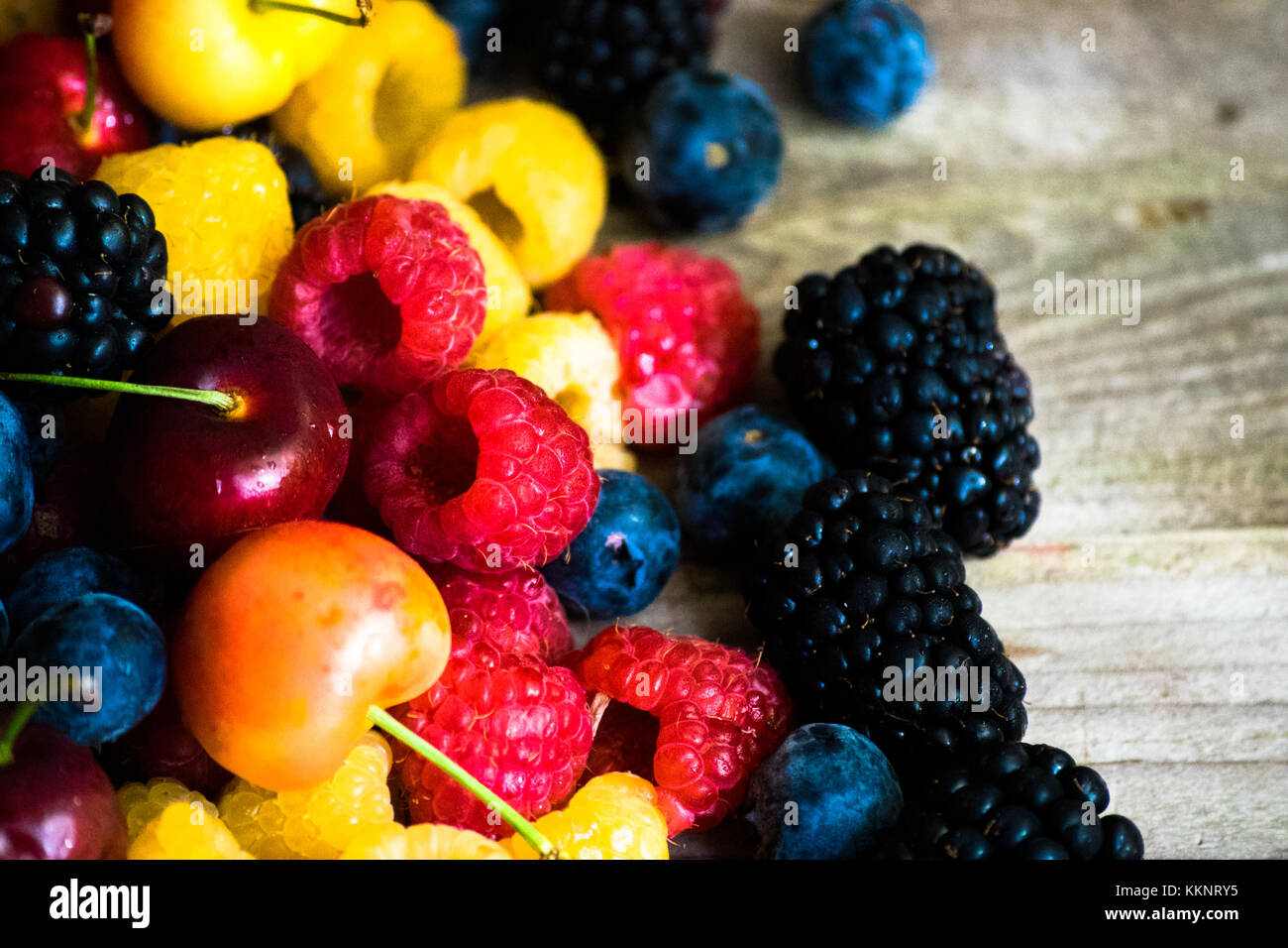 Mix of berries on wooden background Stock Photo