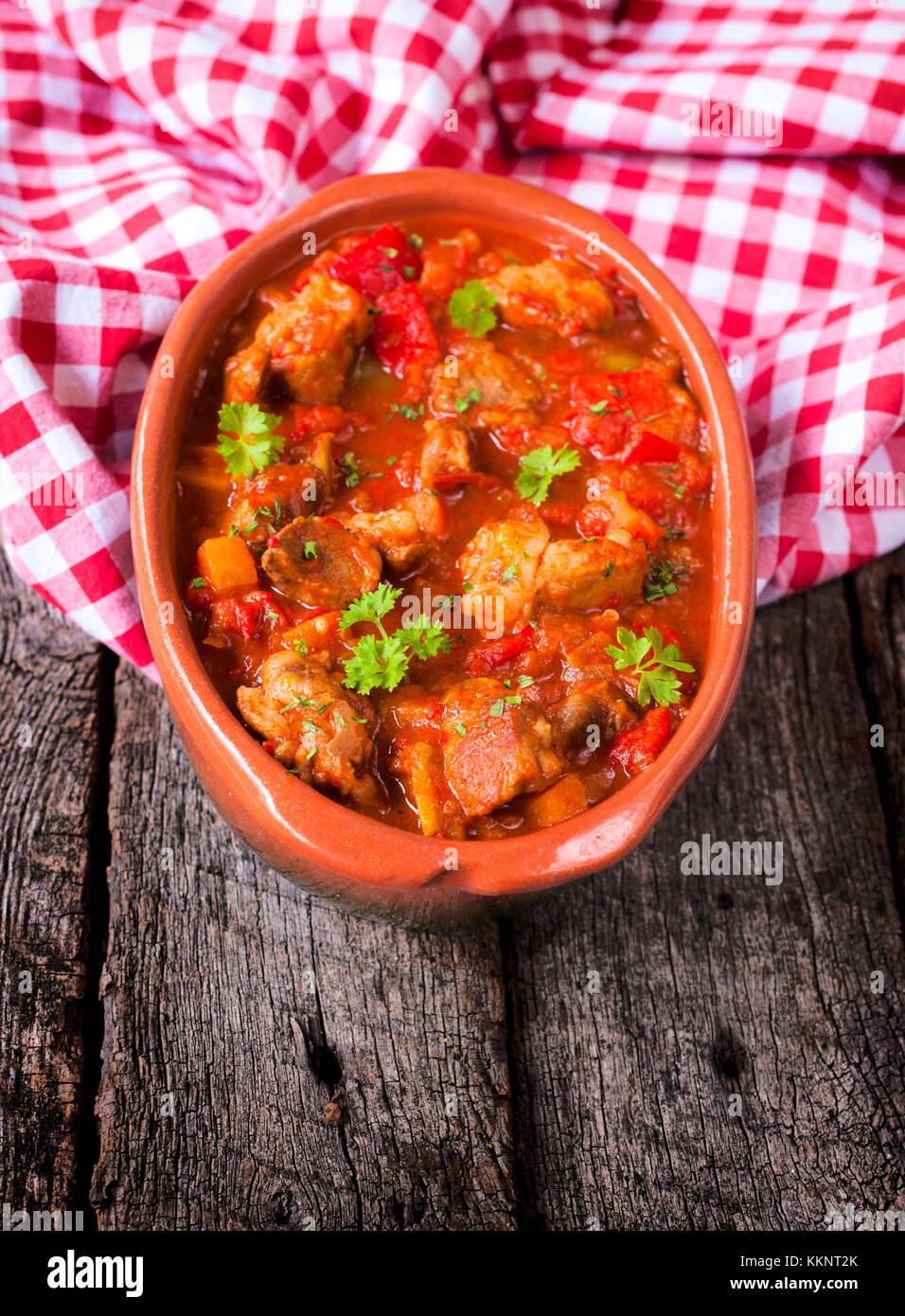 Portion of the beef gulash in bowl on wooden table Stock Photo