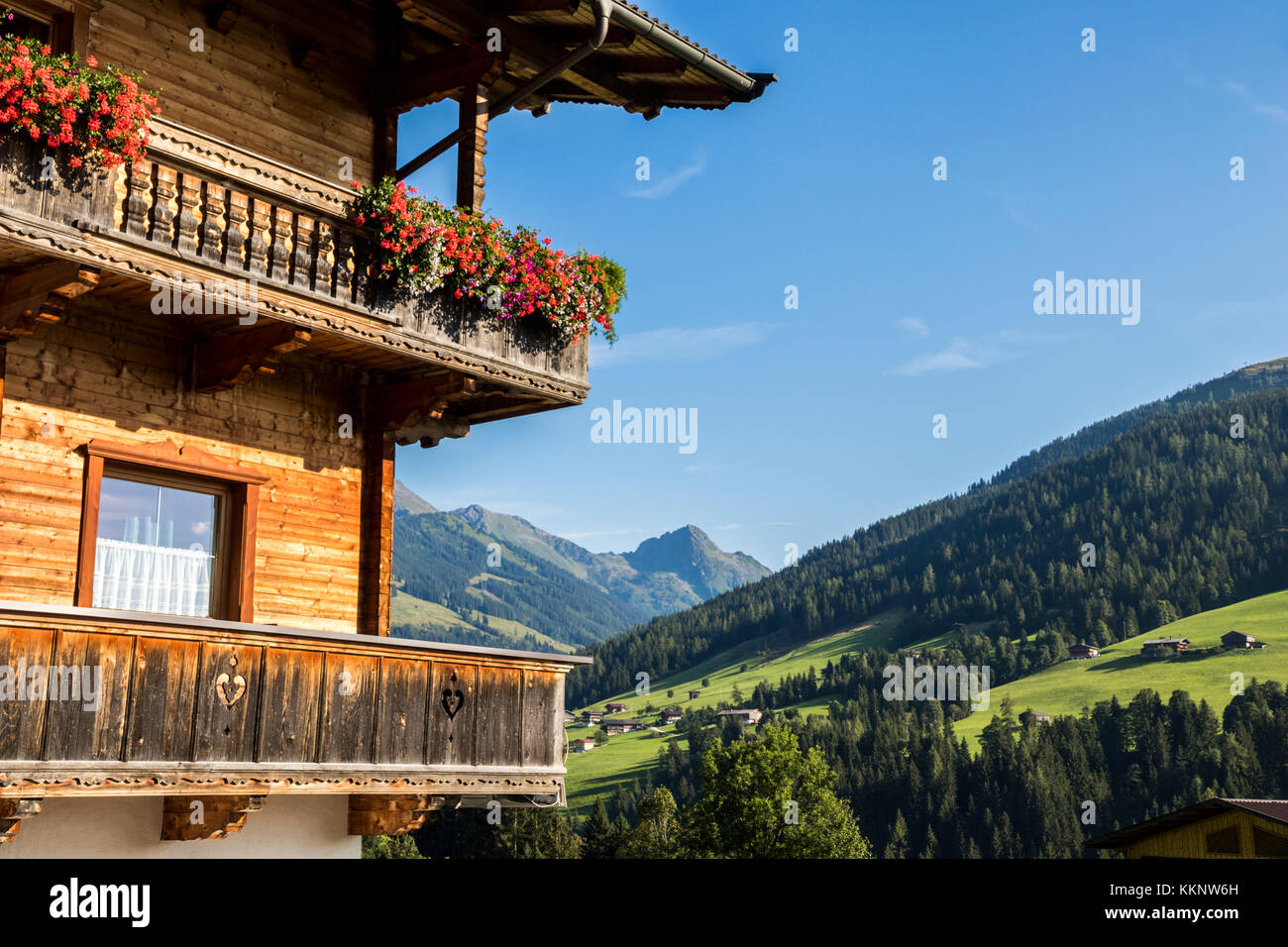 A typical wooden balcony with flowers in Alpbach, a town in western Austria in the state of Tyrol Stock Photo