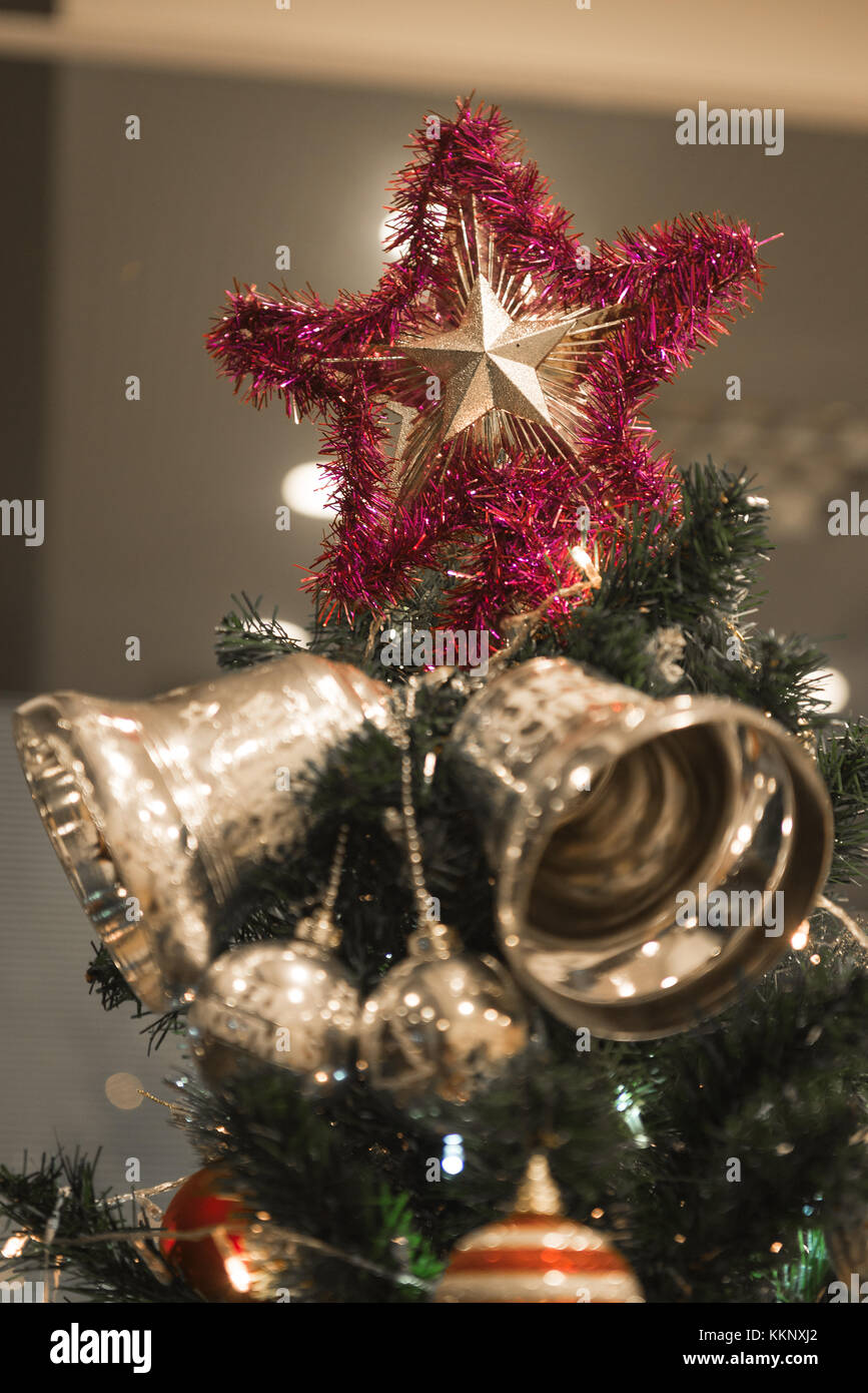 Christmas Silver bell and star hanging on a beautiful Christmas tree ...