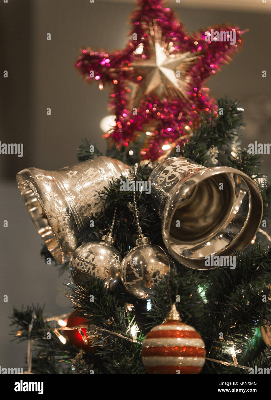 Christmas Silver bell and star hanging on a beautiful Christmas tree ...