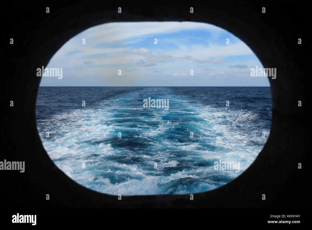 Wake of a Ship at Sea Viewed Through Porthole Stock Photo