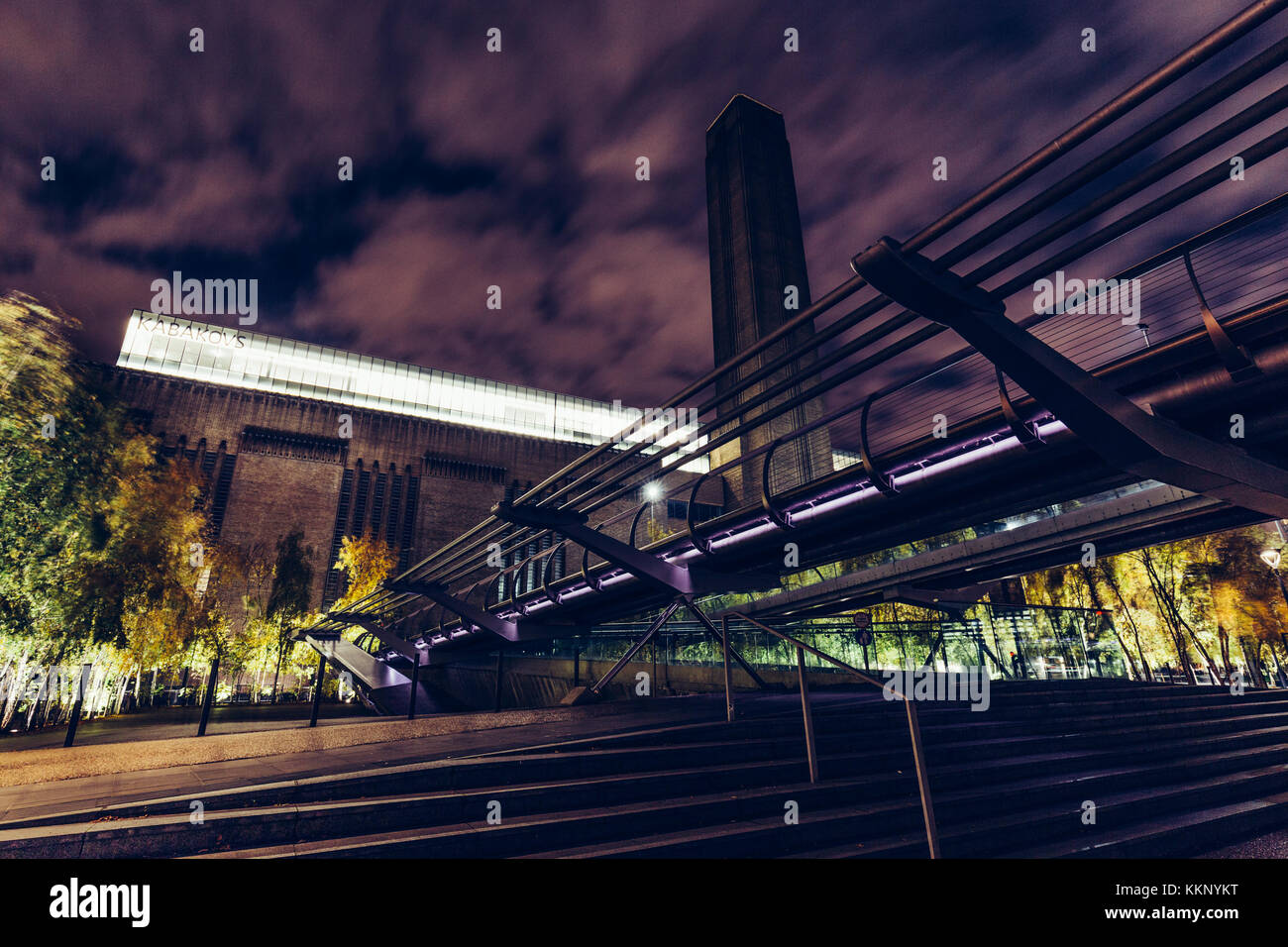 Low angle view of the Tate Modern building and Millennium Bridge  in London at night Stock Photo