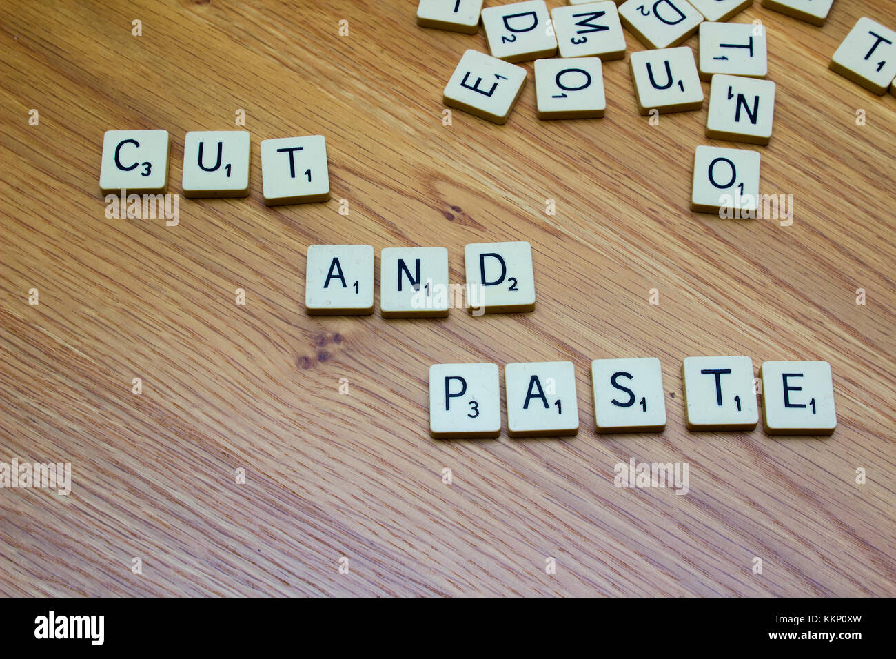 1 December 2017 Ivory board game letters saying Cut and Paste on an oak