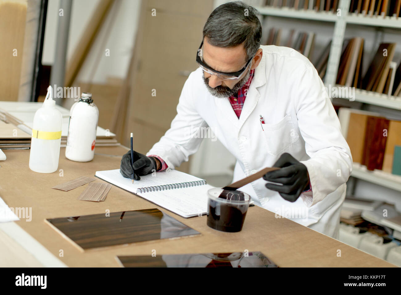 View at engineer in the laboratory examines ceramic tiles Stock Photo