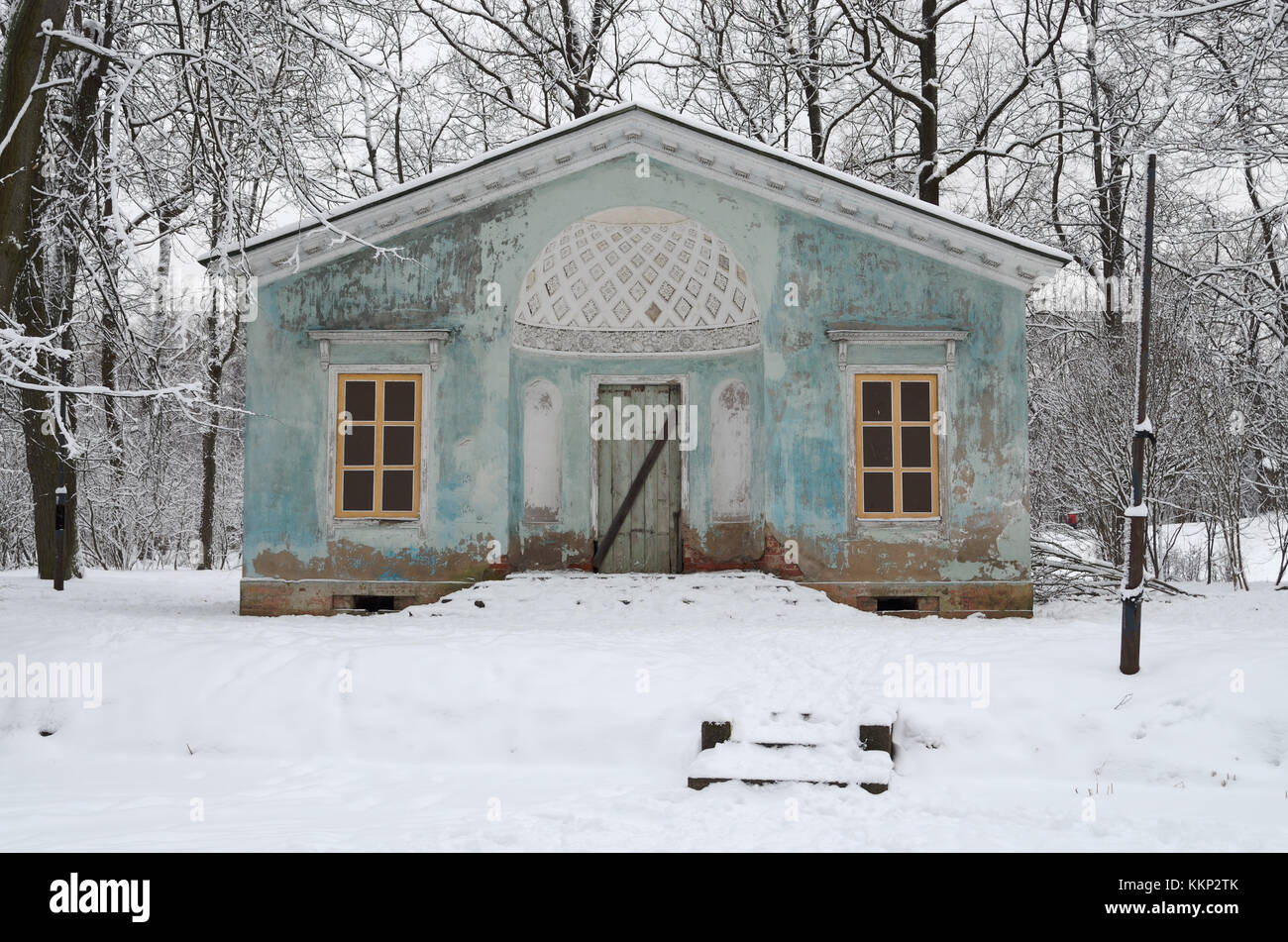 Abandoned house in the woods on the riverbank all covered with snow ...