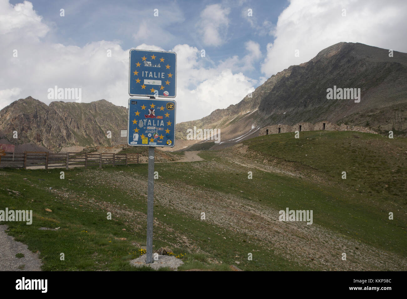 Road sign on road by border linking France and Italy at Col de la Lombarde Stock Photo