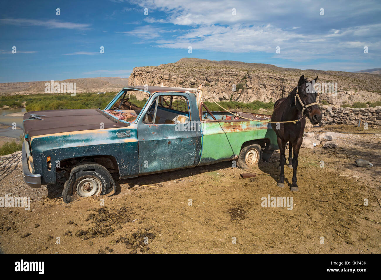 Boquillas del Carmen, Coahuila, Mexico - A dilapidated truck serves as a hitching post for a horse in the small border town of Boquillas. The town is  Stock Photo