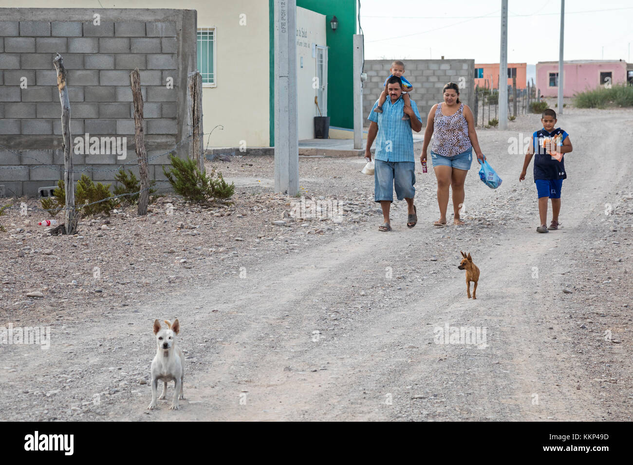 Boquillas del Carmen, Coahuila, Mexico - A family walks on a dusty street in the small border town of Boquillas. The town is popular with tourists who Stock Photo