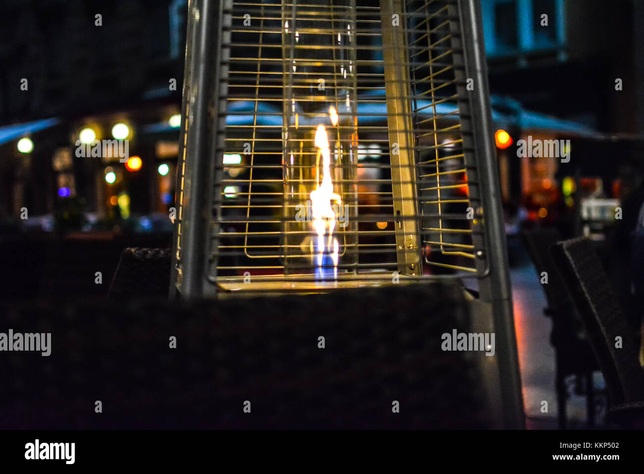 A flame heater keeps tables warm in the late evening at an outdoor cafe in Split Croatia. Stock Photo
