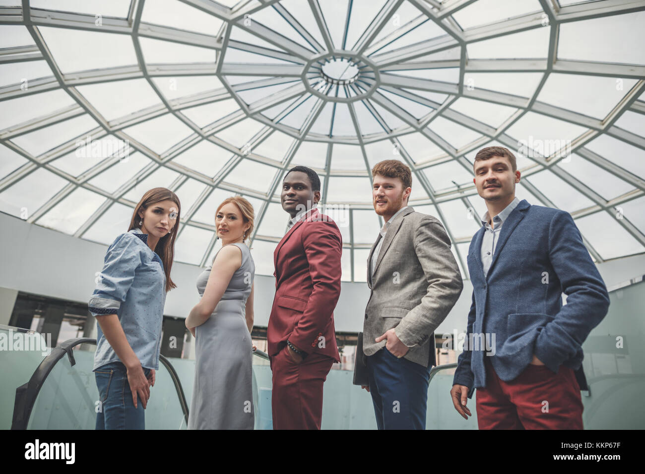 group of business people smiling in an office lined up Stock Photo - Alamy