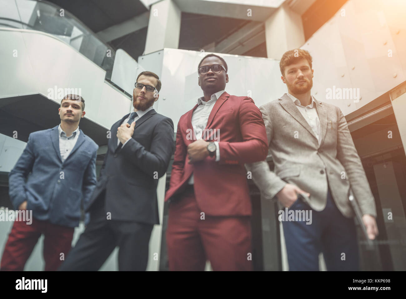 group of business people smiling in an office lined up Stock Photo - Alamy