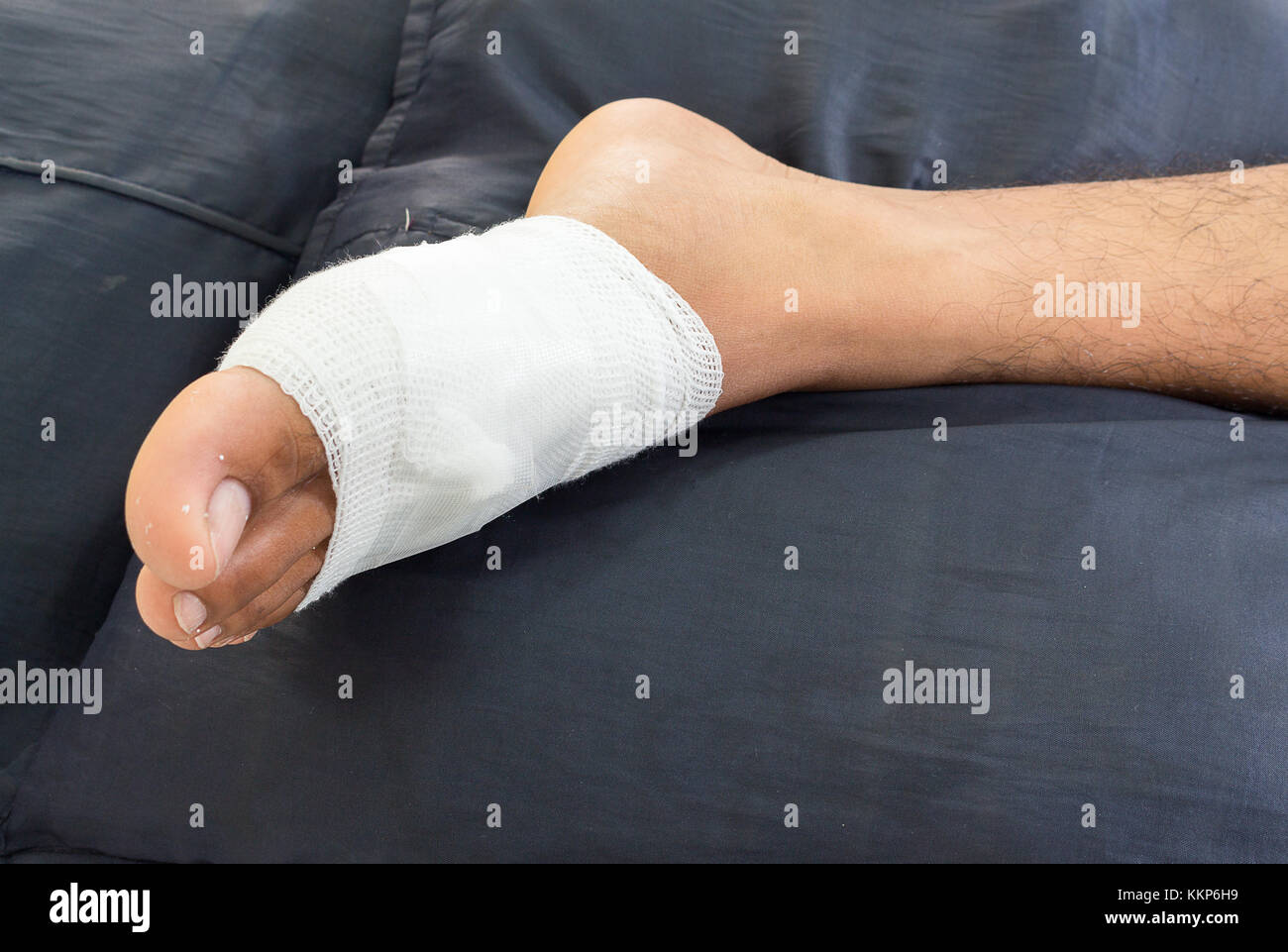 Gauze bandage the foot,treating patients with foot ulcers,male is wrapping his Foot injury with