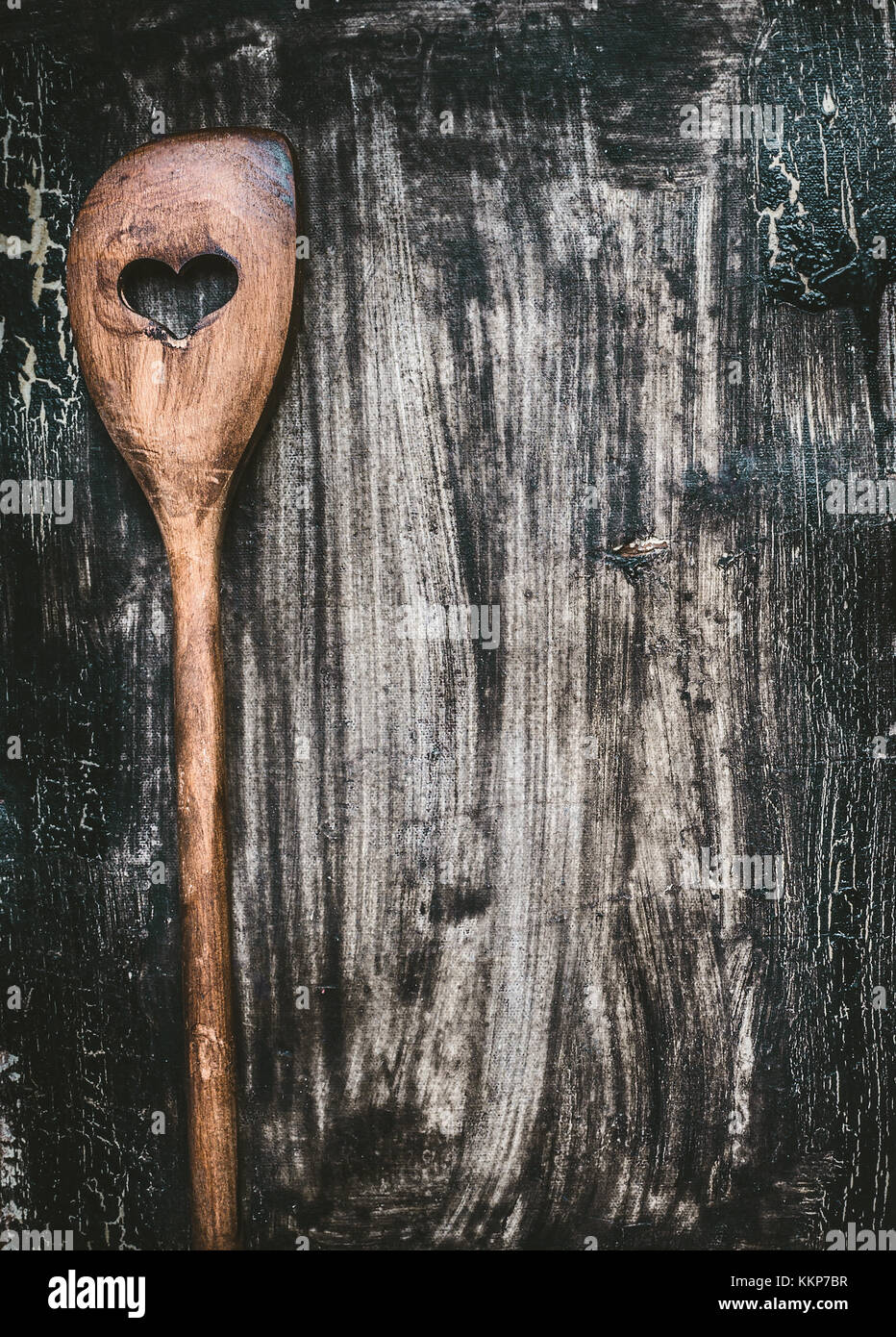 Wooden cooking spoon with heart on dark rustic background, top view ...