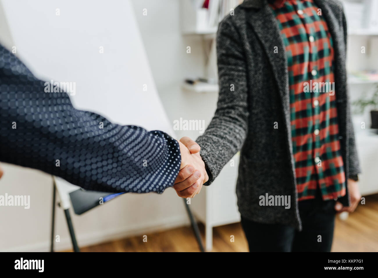 Businessman welcoming new client with a firm handshake Stock Photo