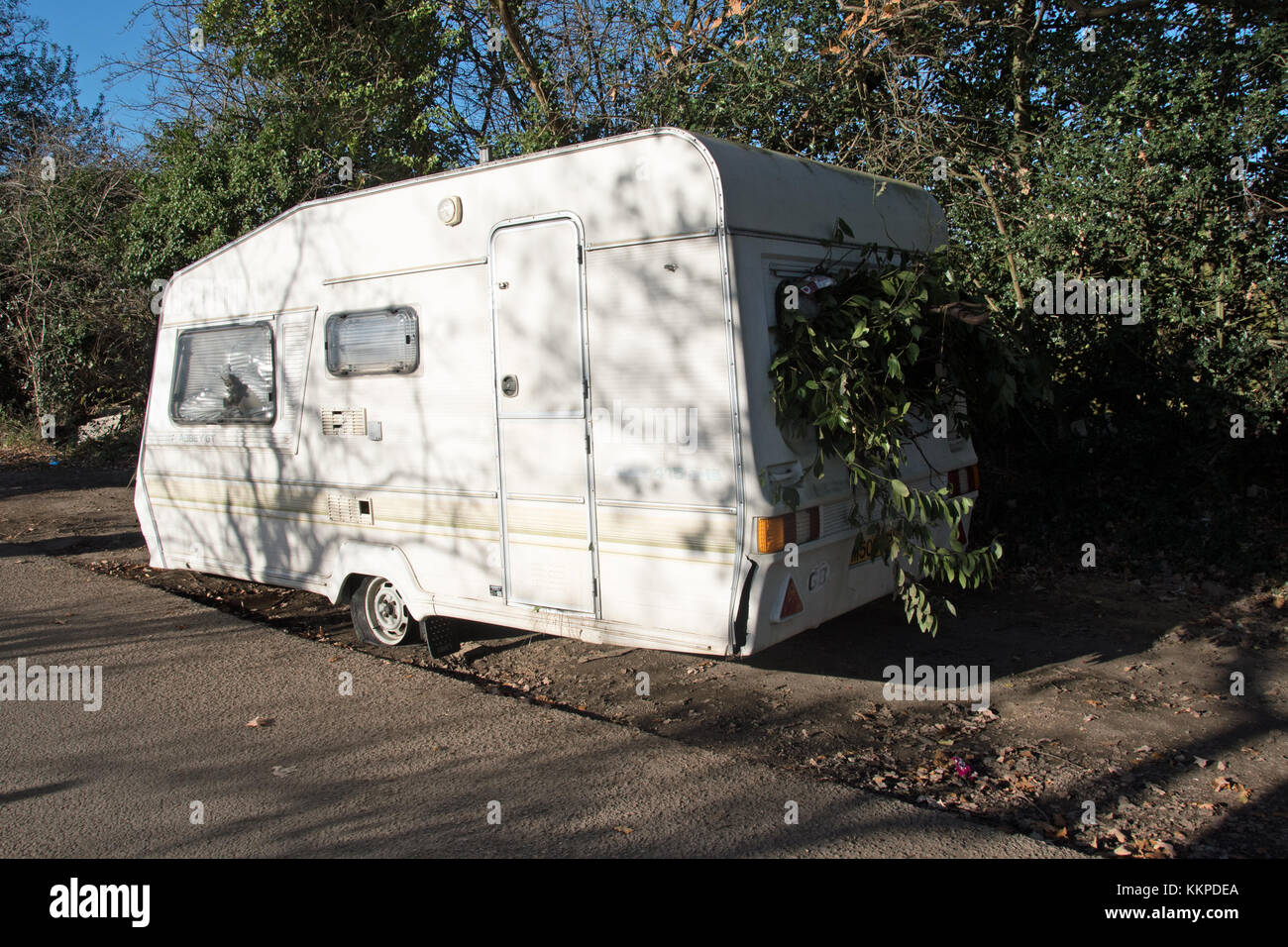 A travellers caravan loaded with garden waste is dumped in the leafy