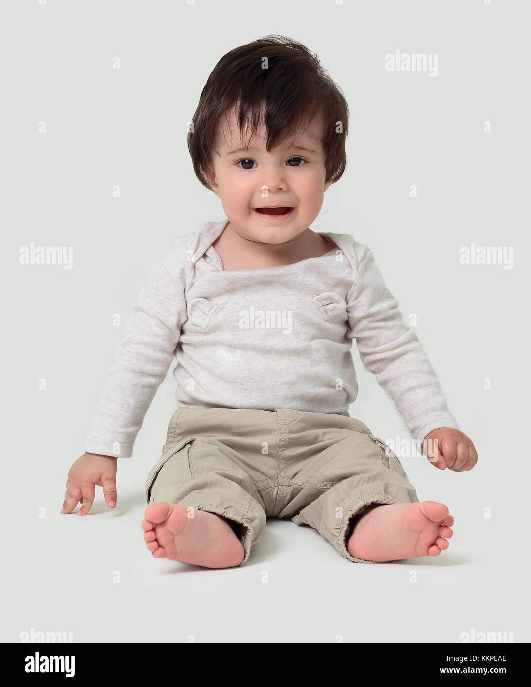 Funny baby sitting on the floor, isolated over white Stock Photo Alamy