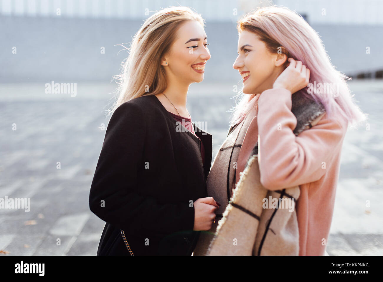 Two Girls Talking To Each Other And Laughing, Autumn Clothing Stock 