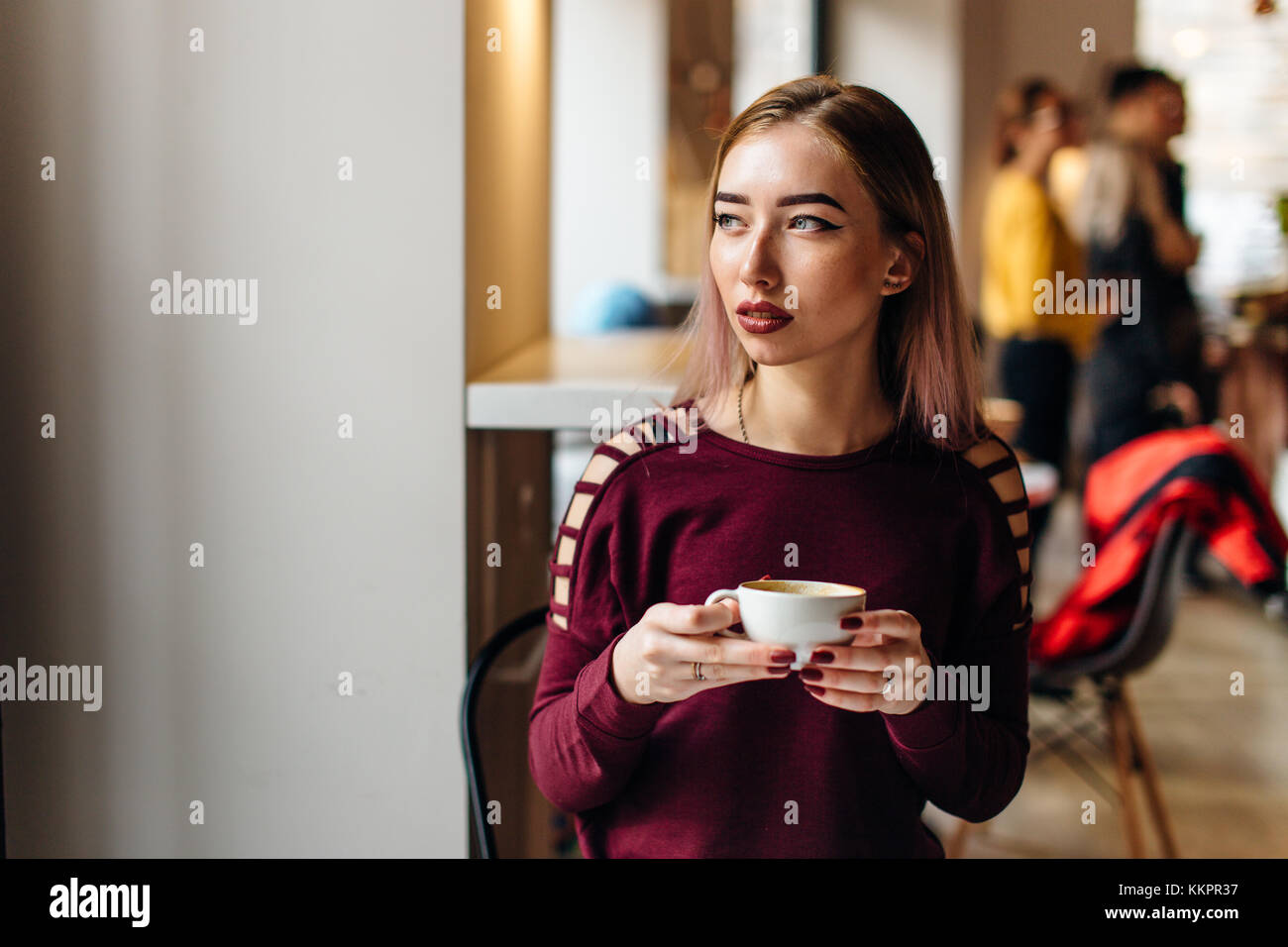 Young girl sit with cup of coffee and smile to the camera Stock Photo ...